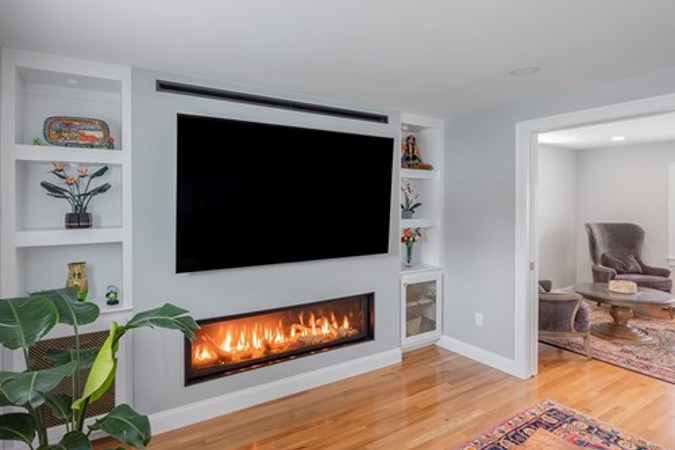 After: Contemporary family room with gas fireplace and beautiful entry