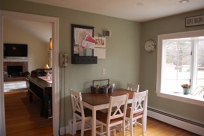 Before: Small eating area with wall dividing spaces